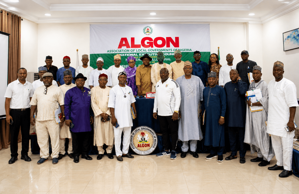ALGON NEC Endorses Tinubu for 2027, Enforces Discipline, Reaffirms Leadership in Sweeping Abuja Resolutions Nigeria’s foremost umbrella body for local government leadership, the Association of Local Governments of Nigeria (ALGON), has taken far-reaching decisions that blend political alignment, institutional discipline, and leadership consolidation, following its 54th (Expanded) National Executive Council (NEC) meeting held in Abuja. The high-stakes meeting, convened on Wednesday, April 29, 2026, brought together council chairmen from across the 36 states and the Federal Capital Territory, alongside past national leaders and members of the Board of Trustees. It was presided over by ALGON National President, Hon. (Engr.) Bello Lawal, with deliberations focusing on both the state of the association and broader national developments. According to the official communiqué signed by Hon. Anani Hamisu Mohammed, ALGON Chairman in Plateau State and National Publicity Secretary, the NEC—described as “the decision-making organ of the Association of Local Governments of Nigeria (ALGON)”—undertook “robust deliberation on the state of the Association and the nation” before arriving at unanimous resolutions. Tinubu Endorsed Amid Praise for Grassroots Reforms In what stands as the most politically significant outcome of the meeting, ALGON formally endorsed President Bola Ahmed Tinubu for re-election in 2027, aligning the association squarely with the federal administration. “The National Executive Council unanimously endorsed President Bola Ahmed Tinubu, GCFR for re-election come 2027,” the communiqué stated. The council went further to “declare total solidarity with the President’s Renewed Hope Agenda,” emphasizing that “his policy trajectory has restored dignity, fiscal capacity and functional autonomy to Nigeria’s 774 Local Governments and Area Councils.” For ALGON, which represents grassroots governance nationwide, the perceived restoration of autonomy and improved fiscal capacity under the current administration formed the core justification for its endorsement. “NEC recognised that continuity of his administration will deepen the grassroots governance,” the statement added, underscoring the association’s belief that sustained leadership is essential for consolidating ongoing reforms. The motion for endorsement was moved by former ALGON National President Hon. Alabi Kolade David and seconded by Hon. Anani Hamisu Mohammed, and was adopted unanimously—reflecting a rare consensus across the federation’s local government leadership. Firm Disciplinary Measures Against Members Beyond political positioning, the NEC also addressed internal challenges within the association, taking decisive steps to enforce discipline and preserve unity. The council unanimously endorsed the indefinite suspension of three prominent local government chairmen over allegations of misconduct. Those affected are Hon. Zakari Iliyasu, Chairman of Agwara Local Government Area and ALGON Chairman in Niger State; Hon. Abubakar Danladi Abdullahi, Chairman of Kaiama LGA and ALGON Chairman in Kwara State; and Hon. Abba Shehu Tambuwal, Chairman of Tambuwal LGA and ALGON Chairman in Sokoto State. According to the communiqué, the suspensions were based on findings of “impersonation, acting against the interest of the Association and abuse of constitutional provisions of the Association.” In a strongly worded disclaimer, ALGON made it clear that the affected individuals no longer have the mandate to represent the association in any capacity. “The NEC hereby put on notice (MDAs, State Governments, Development Partners, International Organizations, Associates, Stakeholders, Friends and indeed the general public) that the above-mentioned Local Government Chairmen do not have the authority of the NEC to act on behalf of the Association,” the communiqué declared. It further cautioned that “the general public is urged to be cautious as ALGON will not be responsible for illegal acts and omission by these individuals.” The motion leading to the suspensions was moved by Hon. (Dr.) Gbenga Fasua, ALGON Chairman in Ondo State, and seconded by Hon. Muhammad Dahiru Ambursa, ALGON Chairman in Kebbi State. Vote of Confidence in National Leadership Amid the disciplinary actions, the NEC moved to reinforce leadership stability by passing a unanimous vote of confidence in ALGON National President, Hon. (Engr.) Bello Lawal. “NEC with one voice, unanimously passed a vote of confidence in the leadership of the National President,” the communiqué stated. The council pledged continued loyalty and support to the executive committee, emphasizing its determination to maintain unity within the association. “NEC pledged its loyalty and support to the EXco and vowed to fight against any force that will bring disunity to the Association,” the statement noted. ALGON also commended Lawal’s leadership style, praising “the strategic foresight and relentless drive in repositioning ALGON through multisectoral engagement and inter-agency collaboration.” The motion for the vote of confidence was moved by Hon. Lelei Isaac Tariye, ALGON Chairman in Bayelsa State, and seconded by Hon. Sefianu Isa, ALGON Chairman in Nasarawa State. Security Agencies Called to Action In a final resolution, the NEC called on Nigeria’s security agencies to take decisive action against individuals allegedly impersonating officials of the association, a move seen as part of broader efforts to safeguard its institutional integrity. “NEC urge security agencies in the country to deal decisively with any individual or persons illegally parading themselves as agents or officials of ALGON,” the communiqué concluded. A Defining Moment for ALGON The outcomes of the 54th NEC meeting signal a defining moment for ALGON as it seeks to balance internal cohesion with external political influence. By endorsing President Tinubu, the association has positioned itself as a key stakeholder in the lead-up to the 2027 general elections. At the same time, its disciplinary actions against erring members reflect a renewed commitment to institutional order and constitutional compliance. The reaffirmation of confidence in its national leadership further underscores a strategic effort to project unity and stability at a time when grassroots governance is increasingly central to national development and electoral mobilization. With representation across Nigeria’s 774 local government areas, ALGON’s resolutions are expected to have significant implications—not only for internal governance within the association but also for the broader political landscape as the country inches closer to another election cycle.